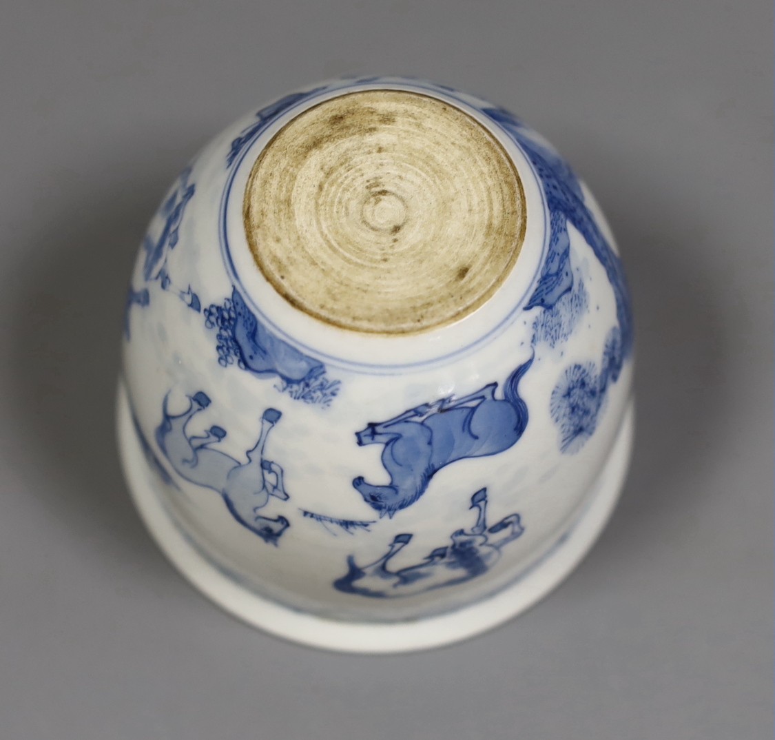 A Chinese blue and white ‘eight horses’ brush pot, on wooden stand, 8cm tall including stand